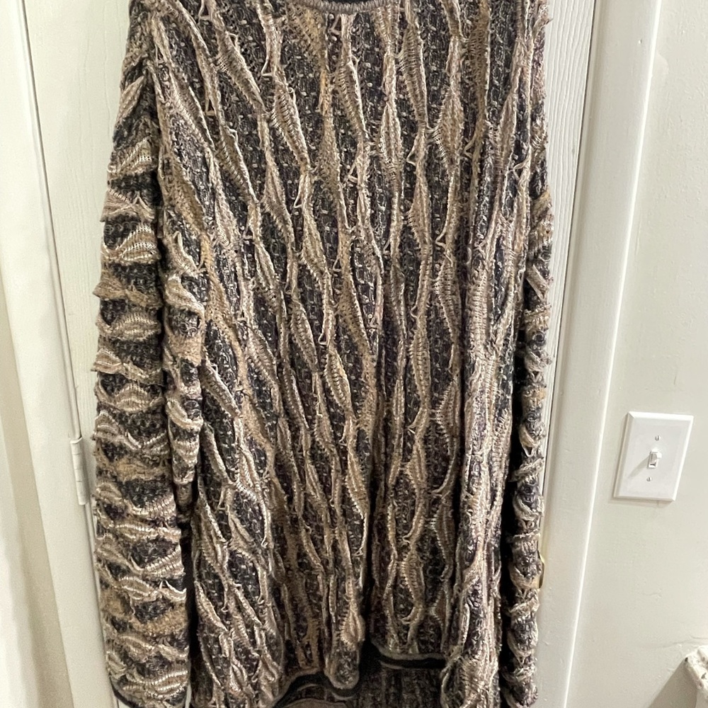 I am selling a Coogi sweater never worn dry cleaned.
